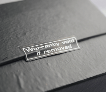  A black box displaying a sticker that reads "Warranty Voided," indicating potential returns fraud.