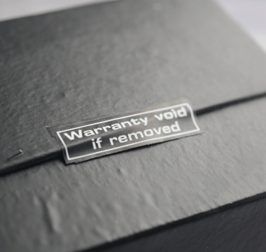  A black box displaying a sticker that reads "Warranty Voided," indicating potential returns fraud.