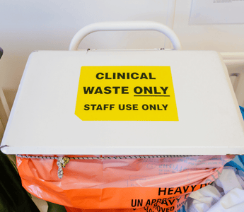 A white box displaying a sign about clinical waste sacks and their traceability with security seals.