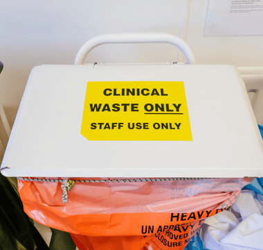 A white box displaying a sign about clinical waste sacks and their traceability with security seals.