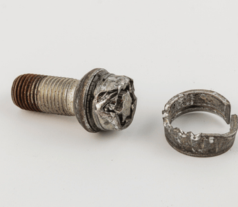 A screw and a circular ring displayed together, highlighting their metallic textures and shapes.