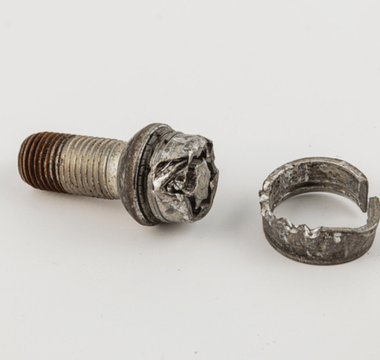 A screw and a circular ring displayed together, highlighting their metallic textures and shapes.